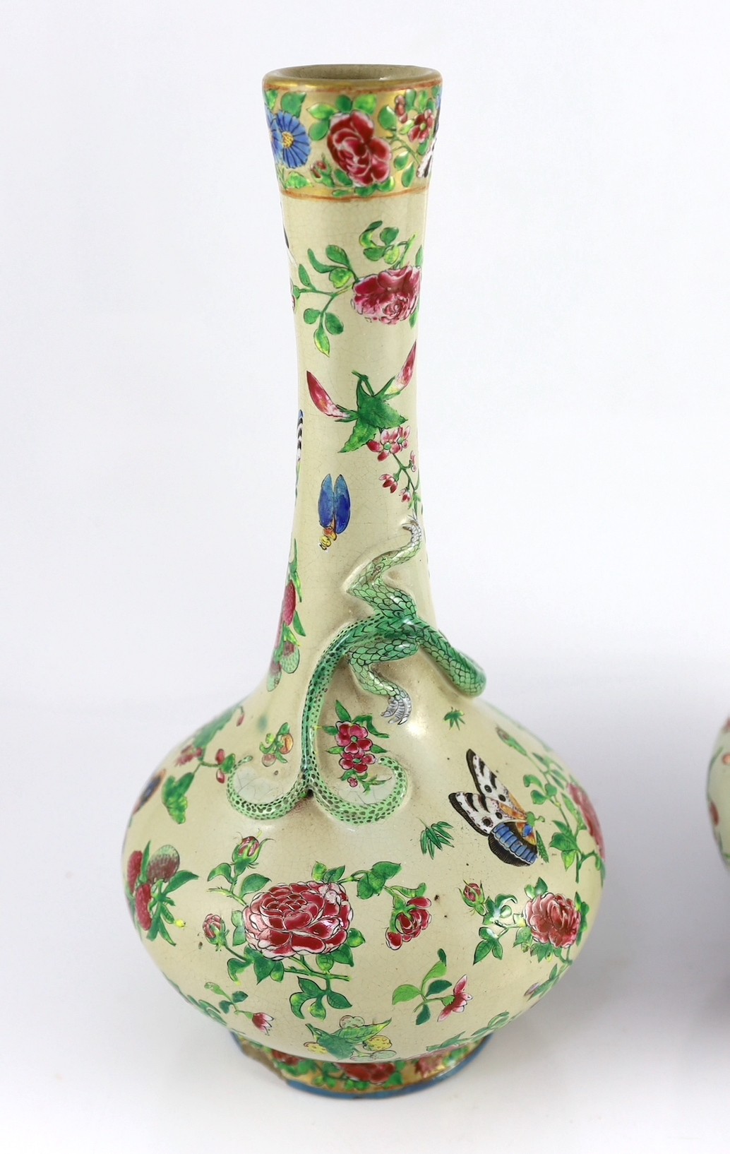 A pair of Chinese enamelled porcelain crackle glaze bottle vases, mid 19th century, 33cm high, chips to feet